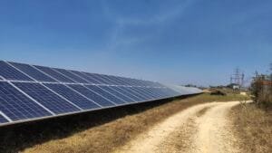 Solar panels in India with electric grid behind